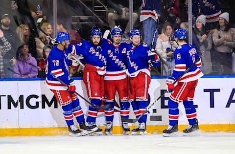 Mar 4, 2022; New York, New York, USA; New York Rangers left wing Chris Kreider (20) celebrates a goal with center Mika Zibanejad (93) and left wing Alexis Lafrenire (13) against the New Jersey Devils during the third period at Madison Square Garden. Mandatory Credit: Danny Wild-USA TODAY Sports