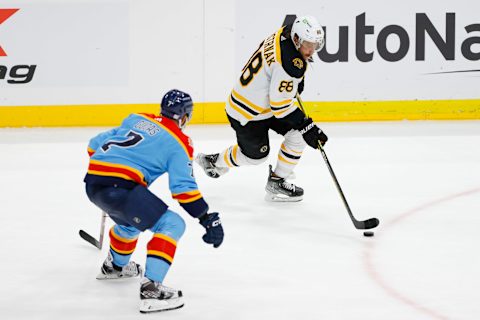 Nov 23, 2022; Sunrise, Florida, USA; Boston Bruins right wing David Pastrnak (88) moves the puck as Florida Panthers defenseman Radko Gudas (7) defends during the third period at FLA Live Arena. Mandatory Credit: Sam Navarro-USA TODAY Sports