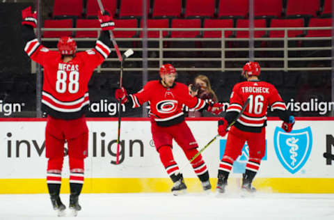 Jan 31, 2021; Raleigh, North Carolina, USA; Carolina Hurricanes right wing Nino Niederreiter (21) celebrates his goal with center Vincent Trocheck (16) and center Martin Necas (88) against the Dallas Stars at PNC Arena. Mandatory Credit: James Guillory-USA TODAY Sports