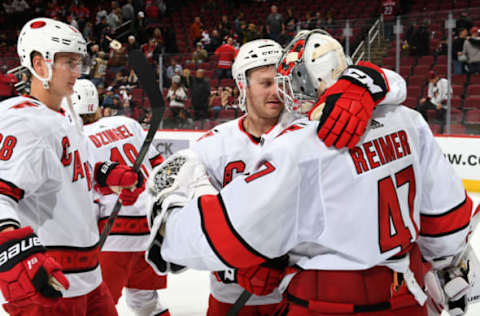 GLENDALE, ARIZONA – FEBRUARY 06: Lucas Wallmark #71 and Martin Necas #88 of the Carolina Hurricanes congratulate goalie James Reimer #47 of the Hurricanes following a 5-3 victory against the Arizona Coyotes during the NHL hockey game at Gila River Arena on February 06, 2020 in Glendale, Arizona. (Photo by Norm Hall/NHLI via Getty Images)