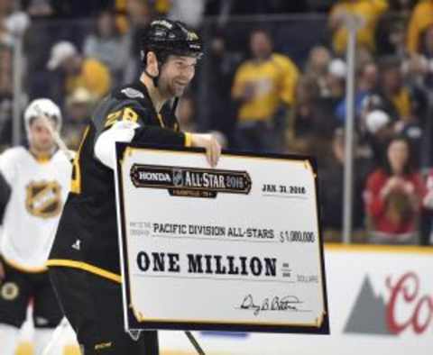 Jan 31, 2016; Nashville, TN, USA; Pacific Division forward John Scott (28) of the Montreal Canadiens skates with the winning check after the championship game of the 2016 NHL All Star Game at Bridgestone Arena. Mandatory Credit: Christopher Hanewinckel-USA TODAY Sports