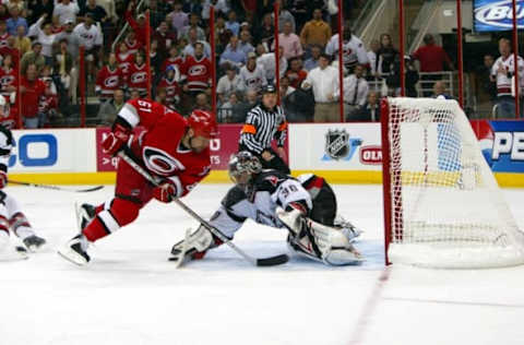 RALEIGH, NC – MAY 22: Left wing Cory Stillman #61 of the Carolina Hurricanes attempts to score on goalie Ryan Miller #30 of the Buffalo Sabres in game two of the Eastern Conference Finals during the 2006 NHL Playoffs on May 22, 2006 at the RBC Center in Raleigh, North Carolina. The Hurricanes won 4-3. (Photo by Bruce Bennett/Getty Images)