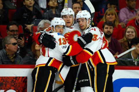 Feb 26, 2017; Raleigh, NC, USA; Calgary Flames forward Micheal Ferland (79) celebrates his second period goal with forward Johnny Gaudreau (13) and forward Sean Monahan (23) against the Carolina Hurricanes at PNC Arena. Mandatory Credit: James Guillory-USA TODAY Sports