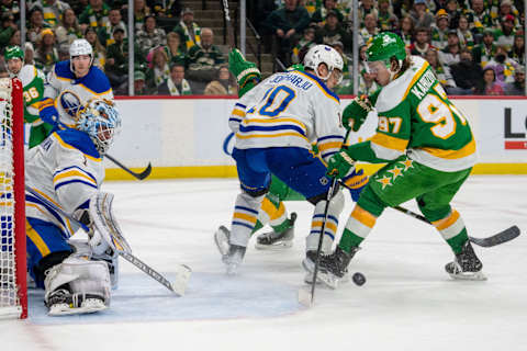 Jan 28, 2023; Saint Paul, Minnesota, USA; Minnesota Wild left wing Kirill Kaprizov (97) has the puck knocked away as he shoots on Buffalo Sabres goaltender Ukko-Pekka Luukkonen (1) in the second period at Xcel Energy Center. Mandatory Credit: Matt Blewett-USA TODAY Sports