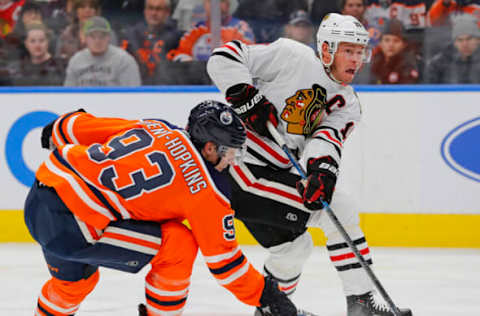 Edmonton Oilers forward Ryan Nugent-Hopkins (93) tries to block a shot by Chicago Blackhawks forward Jonathan Toews (19) Mandatory Credit: Perry Nelson-USA TODAY Sports