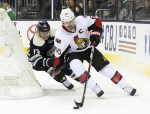 Feb 13, 2016; Columbus, OH, USA; Ottawa Senators defenseman Erik Karlsson (65) carries the puck under pressure from Columbus Blue Jackets right wing Cam Atkinson (13) at Nationwide Arena. The Blue Jackets won the game 4-2. Mandatory Credit: Greg Bartram-USA TODAY Sports