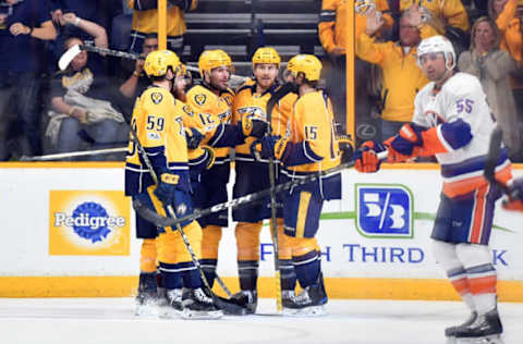 Apr 4, 2017; Nashville, TN, USA; Nashville Predators center Mike Fisher (12) is congratulated by teammates after a goal during the second period against the New York Islanders at Bridgestone Arena. Mandatory Credit: Christopher Hanewinckel-USA TODAY Sports