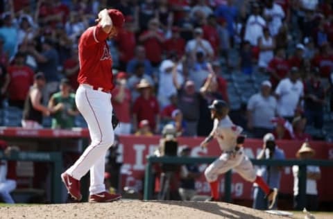 Jul 31, 2016; Anaheim, CA, USA; Los Angeles Angels pitcher Huston Street (left) reacts after allowing a three-run home run to Boston Red Sox second baseman Dustin Pedroia (right) during the ninth inning at Angel Stadium of Anaheim. Mandatory Credit: Kelvin Kuo-USA TODAY Sports