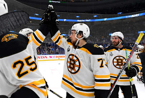 ST. LOUIS, MISSOURI – JUNE 09: Charlie McAvoy #73 and John Moore #27 of the Boston Bruins and their teammates celebrate on the ice after Game Six of the 2019 NHL Stanley Cup Final at Enterprise Center on June 09, 2019 in St Louis, Missouri. The Bruins defeated the Blues 5-1. (Photo by Brian Babineau/NHLI via Getty Images)