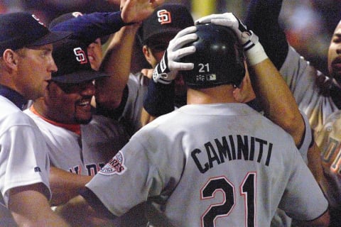 Ken Caminiti(C) of the San Diego Padres is congratulated by teammates after hitting a game-winning solo home run in the 10th inning of Game 1 of the National League Championship Series against the Atlanta Braves 08 October at Turner Field in Atlanta,Ga. The Padres beat the Braves 3-2 in ten innings to take a 1-0 lead in the best-of-seven series. (ELECTRONIC IMAGE) AFP PHOTO/Steve SCHAEFER (Photo by STEVE SCHAEFER / AFP) (Photo credit should read STEVE SCHAEFER/AFP via Getty Images)