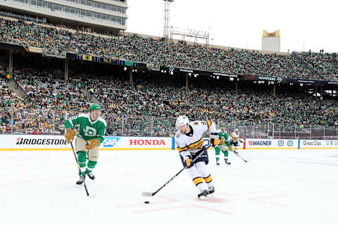 Filip Forsberg #9 of the Nashville Predators carries the puck against Jamie Oleksiak #2 of the Dallas Stars during the Bridgestone NHL Winter Classic. (Photo by Ronald Martinez/Getty Images)