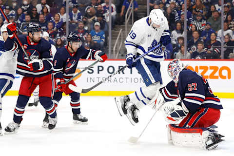 Toronto Maple Leafs, Calle Jarnkrok (19); Winnipeg Jets, Connor Hellebuyck (37). Mandatory Credit: James Carey Lauder-USA TODAY Sports