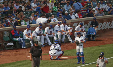 CHICAGO, IL – SEPTEMBER 06: A fan leans in and tries to talk to members of the Chicago Cubs bullpen during a game against the Milwaukee Brewers at Wrigley Field on September 6, 2013 in Chicago, Illinois. (Photo by Jonathan Daniel/Getty Images)