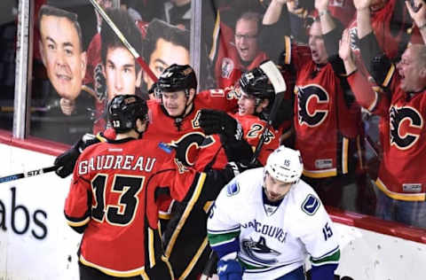 Apr 25, 2015; Calgary, Alberta, CAN; Calgary Flames left wing Johnny Gaudreau (13) center Jiri Hudler (24) and center Sean Monahan (23) celebrate Monhan