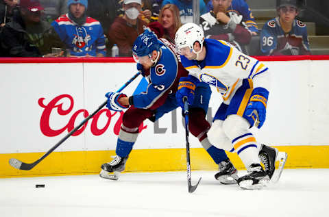 Jan 30, 2022; Denver, Colorado, USA; Buffalo Sabres defenseman Mattias Samuelsson (23) and Colorado Avalanche right wing Valeri Nichushkin (13) battle for the puck in the second period at Ball Arena. Mandatory Credit: Ron Chenoy-USA TODAY Sports