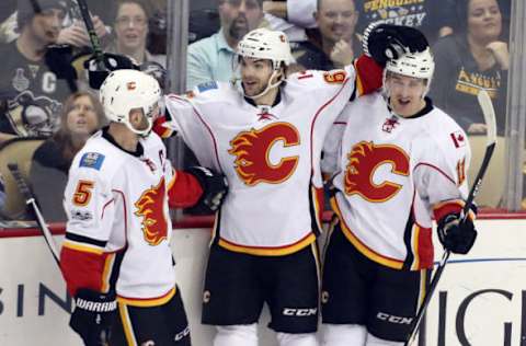 NHL Power Rankings: Calgary Flames defenseman Mark Giordano (5) and right wing Michael Frolik (67) and center Mikael Backlund (11) celebrate after Frolik scored a goal against the Pittsburgh Penguins during the second period at the PPG PAINTS Arena. Mandatory Credit: Charles LeClaire-USA TODAY Sports