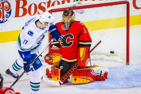 Feb 19, 2016; Calgary, Alberta, CAN; Calgary Flames goalie Jonas Hiller (1) makes a save as Vancouver Canucks right wing Radim Vrbata (17) tries to score during the second period at Scotiabank Saddledome. Mandatory Credit: Sergei Belski-USA TODAY Sports