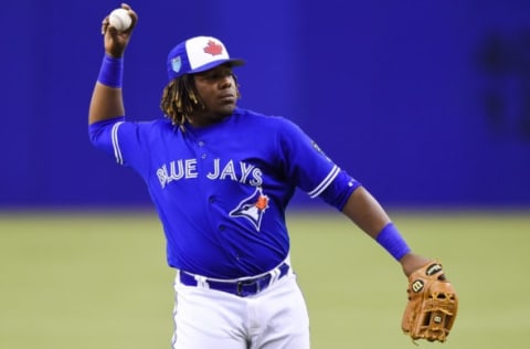 MONTREAL, QC – MARCH 27: Toronto Blue Jays infielder Vladimir Guerrero Jr. (27) pitches the ball during the St. Louis Cardinals versus the Toronto Blue Jays spring training game on March 27, 2018, at Olympic Stadium in Montreal, QC (Photo by David Kirouac/Icon Sportswire via Getty Images)