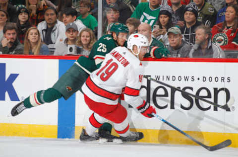 SAINT PAUL, MN – NOVEMBER 16: Dougie Hamilton #19 of the Carolina Hurricanes and Jonas Brodin #25 of the Minnesota Wild collide during the game at the Xcel Energy Center on November 16, 2019 in Saint Paul, Minnesota. (Photo by Bruce Kluckhohn/NHLI via Getty Images)