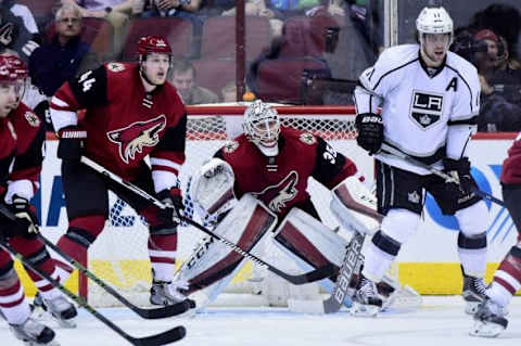 Jan 23, 2016; Glendale, AZ, USA; Arizona Coyotes goalie Louis Domingue (35) and defenseman Kevin Connauton (44) defend as Los Angeles Kings center Anze Kopitar (11) looks on during the second period at Gila River Arena. Mandatory Credit: Matt Kartozian-USA TODAY Sports