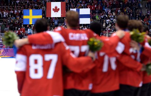 SOCHI, RUSSIA – FEBRUARY 23: The Canada team listen to the national anthem after recieving their gold medals. (Photo by Harry How/Getty Images)