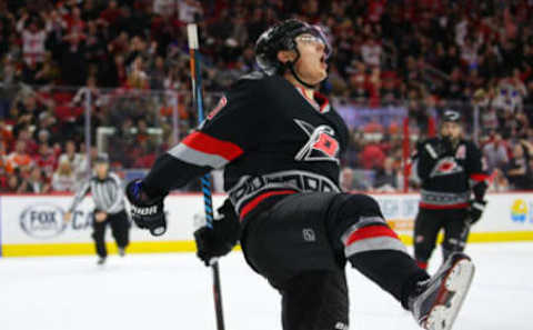 Jan 31, 2017; Raleigh, NC, USA; Carolina Hurricanes forward Sebastian Aho (20) celebrates his hat trick goal during the second period against the Philadelphia Flyers at PNC Arena. Mandatory Credit: James Guillory-USA TODAY Sports