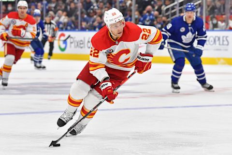 Nov 12, 2021; Toronto, Ontario, CAN; Calgary Flames center Trevor Lewis (22) controls the puck against Toronto Maple Leafs in the third period at Scotiabank Arena. Mandatory Credit: Gerry Angus-USA TODAY Sports