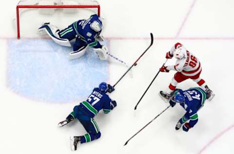 VANCOUVER, BC – DECEMBER 12: Tyler Myers #57 and Quinn Hughes #43 look on as teammate Jacob Markstrom #25 of the Vancouver Canucks makes a save off the shot of Teuvo Teravainen #86 of the Carolina Hurricanes during their NHL game at Rogers Arena December 12, 2019 in Vancouver, British Columbia, Canada. Vancouver won 1-0. (Photo by Jeff Vinnick/NHLI via Getty Images)