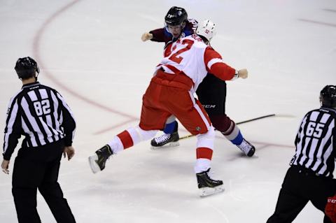 Feb 5, 2015; Denver, CO, USA; Colorado Avalanche center Nathan MacKinnon (29) and Detroit Red Wings defenseman Jonathan Ericsson (52) fight early in the first period at the Pepsi Center. Mandatory Credit: Ron Chenoy-USA TODAY Sports