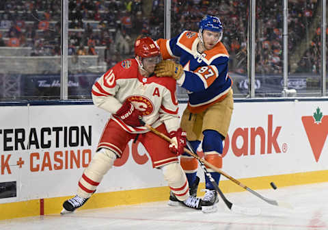 Oct 29, 2023; Edmonton, Alberta, CAN; Calgary Flames centre Jonathan Huberdeau (10) on the ice with Edmonton Oilers centre Connor McDavid (97) during the third period in the 2023 Heritage Classic ice hockey game at Commonwealth Stadium. Mandatory Credit: Walter Tychnowicz-USA TODAY Sports