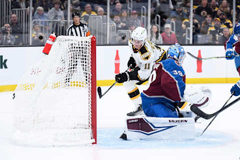 Dec. 3, 2022; Boston, Massachusetts, USA; Boston Bruins center Trent Frederic (11) scores a goal past Colorado Avalanche goaltender Pavel Francouz (39) during the first period at TD Garden. Mandatory Credit: Bob DeChiara-USA TODAY Sports