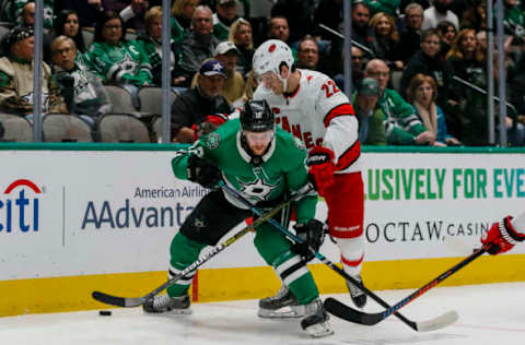 DALLAS, TX – FEBRUARY 11: Dallas Stars center Radek Faksa (12) and Carolina Hurricanes defenseman Brett Pesce (22) battle for the puck during the game between the Dallas Stars and the Carolina Hurricanes on February 11, 2019 at American Airlines Center in Dallas, Texas. (Photo by Matthew Pearce/Icon Sportswire via Getty Images)