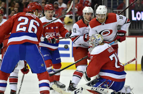 WASHINGTON, DC – MARCH 26: Carolina Hurricanes defenseman Dougie Hamilton (19) and Washington Capitals goalie Braden Holtby (70) watcha puck fly toward the net during the Carolina Hurricanes vs. Washington Capitals NHL game March 26, 2019 at Capital One Arena in Washington, D.C.. (Photo by Randy Litzinger/Icon Sportswire via Getty Images)