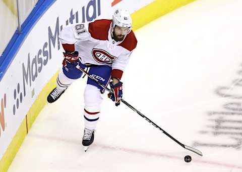 TORONTO, ONTARIO – AUGUST 12: Xavier Ouellet #61 of the Montreal Canadiens passes the puck in the first period against the Philadelphia Flyers in Game One of the Eastern Conference First Round during the 2020 NHL Stanley Cup Playoffs at Scotiabank Arena on August 12, 2020 in Toronto, Ontario. (Photo by Elsa/Getty Images)