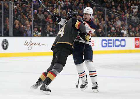 LAS VEGAS, NEVADA – NOVEMBER 23: Nicolas Hague #14 of the Vegas Golden Knights hits Ryan Nugent-Hopkins #93 of the Edmonton Oilers during the third period at T-Mobile Arena on November 23, 2019 in Las Vegas, Nevada. (Photo by Zak Krill/NHLI via Getty Images)