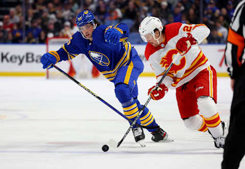 Feb 11, 2023; Buffalo, New York, USA; Buffalo Sabres defenseman Owen Power (25) watches as Calgary Flames right wing Brett Ritchie (24) controls the puck during the third period at KeyBank Center. Mandatory Credit: Timothy T. Ludwig-USA TODAY Sports