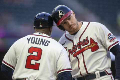 May 19, 2021; Atlanta, Georgia, USA; Atlanta Braves first baseman Freddie Freeman (5) celebrates after a single with first base coach Eric Young Sr. (2) against the New York Mets in the fourth inning at Truist Park. Mandatory Credit: Brett Davis-USA TODAY Sports