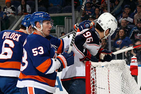 ELMONT, NEW YORK – DECEMBER 29: Casey Cizikas #53 of the New York Islanders pushes Jack Roslovic #96 of the Columbus Blue Jackets into the crossbar during the first period at UBS Arena on December 29, 2022 in Elmont, New York. (Photo by Bruce Bennett/Getty Images)