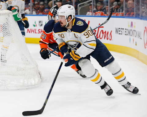 Dec 8, 2019; Edmonton, Alberta, CAN; Buffalo Sabres forward Marcus Johansson (90) moves the puck in front of Edmonton Oilers forward Riley Sheahan (23) during the first period at Rogers Place. Mandatory Credit: Perry Nelson-USA TODAY Sports