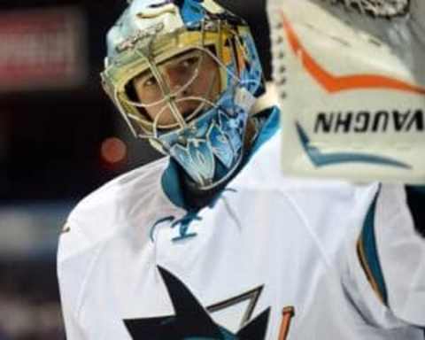 Sep 21, 2015; Victoria, British Columbia, CAN; San Jose Sharks goaltender Troy Grosenick (1) reaches for the puck against the Vancouver Canucks during the first period at Q Centre. Mandatory Credit: Anne-Marie Sorvin-USA TODAY Sports