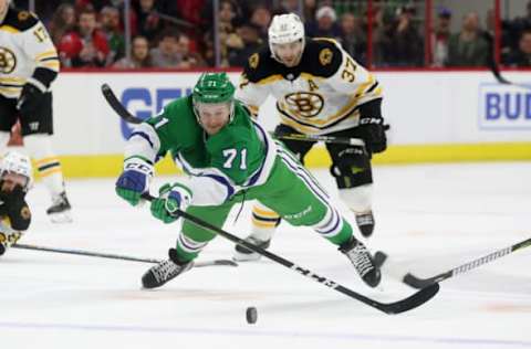 RALEIGH, NC – DECEMBER 23: Lucas Wallmark #71 of the Carolina Hurricanes goes down on the ice to clear a puck through the neutral zone during an NHL game against the Boston Bruins on December 23, 2018 at PNC Arena in Raleigh, North Carolina. (Photo by Gregg Forwerck/NHLI via Getty Images)