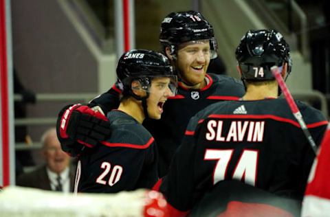 RALEIGH, NC – NOVEMBER 1: Sebastian Aho #20 of the Carolina Hurricanes celebrates with teammates Dougie Hamilton #19 and Jaccob Slavin #74 after scoring a goal during an NHL game against the Detroit Red Wings on November 1, 2019, at PNC Arena in Raleigh, North Carolina. (Photo by Gregg Forwerck/NHLI via Getty Images)