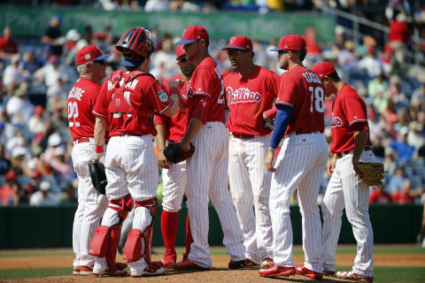 Mar 10, 2017; Clearwater, FL, USA; Philadelphia Phillies pitching coach Bob McClure (22) comes to the mound to take out starting pitcher Clay Buchholz (21) during the third inning against the New York Yankees at Spectrum Field. Mandatory Credit: Kim Klement-USA TODAY Sports