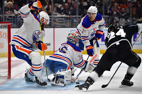 Apr 23, 2023; Los Angeles, California, USA; Edmonton Oilers defenseman Mattias Ekholm (14) and defenseman Evan Bouchard (2) help goaltender Jack Campbell (36) defend the goal against Los Angeles Kings center Phillip Danault (24) during the second period in game four of the first round of the 2023 Stanley Cup Playoffs at Crypto.com Arena. Mandatory Credit: Gary A. Vasquez-USA TODAY Sports