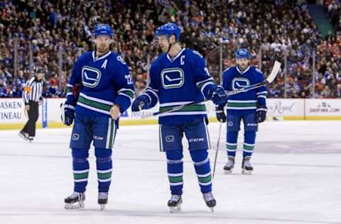 Nov 21, 2015; Vancouver, British Columbia, CAN; Vancouver Canucks forward Daniel Sedin (22) and center Henrik Sedin (33) react against the Chicago Blackhawks at Rogers Arena. Mandatory Credit: Bob Frid-USA TODAY Sports