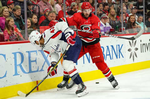 RALEIGH, NC – SEPTEMBER 29: Carolina Hurricanes defenseman Joel Edmundson (6) cross checks Washington Capitals right wing Tom Wilson (43) along the boards during an NHL Preseason game between the Washington Capitals and the Carolina Hurricanes on September 29, 2019 at the PNC Arena in Raleigh, NC. (Photo by Greg Thompson/Icon Sportswire via Getty Images)