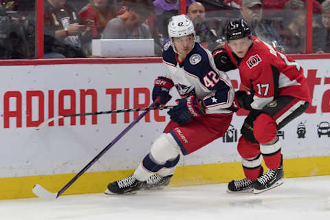 Dec 14, 2019; Ottawa, Ontario, CAN; Columbus Blue Jackets center Alexandre Texier (42) and Ottawa Senators right wing Jonathan Davidsson (17) battle for the puck in the first period at the Canadian Tire Centre. Mandatory Credit: Marc DesRosiers-USA TODAY Sports