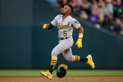 Jul 28, 2023; Denver, Colorado, USA; Oakland Athletics left fielder Tony Kemp (5) loses his helmet as he runs to second on a double in the fifth inning against the Colorado Rockies at Coors Field. Mandatory Credit: Isaiah J. Downing-USA TODAY Sports