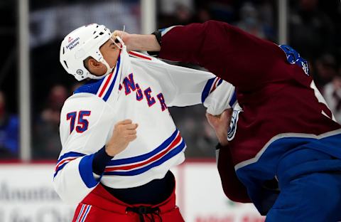 Dec 14, 2021; Denver, Colorado, USA; Colorado Avalanche defenseman Kurtis MacDermid (56) and New York Rangers right wing Ryan Reaves (75) fight in the second period at Ball Arena. Mandatory Credit: Ron Chenoy-USA TODAY Sports