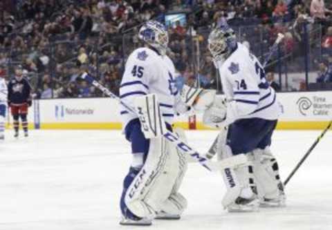 Apr 8, 2015; Columbus, OH, USA; Toronto Maple Leafs goalie Jonathan Bernier (45) enters the game as goalie James Reimer (34) exits against the Columbus Blue Jackets in the second period at Nationwide Arena. Mandatory Credit: Aaron Doster-USA TODAY Sports